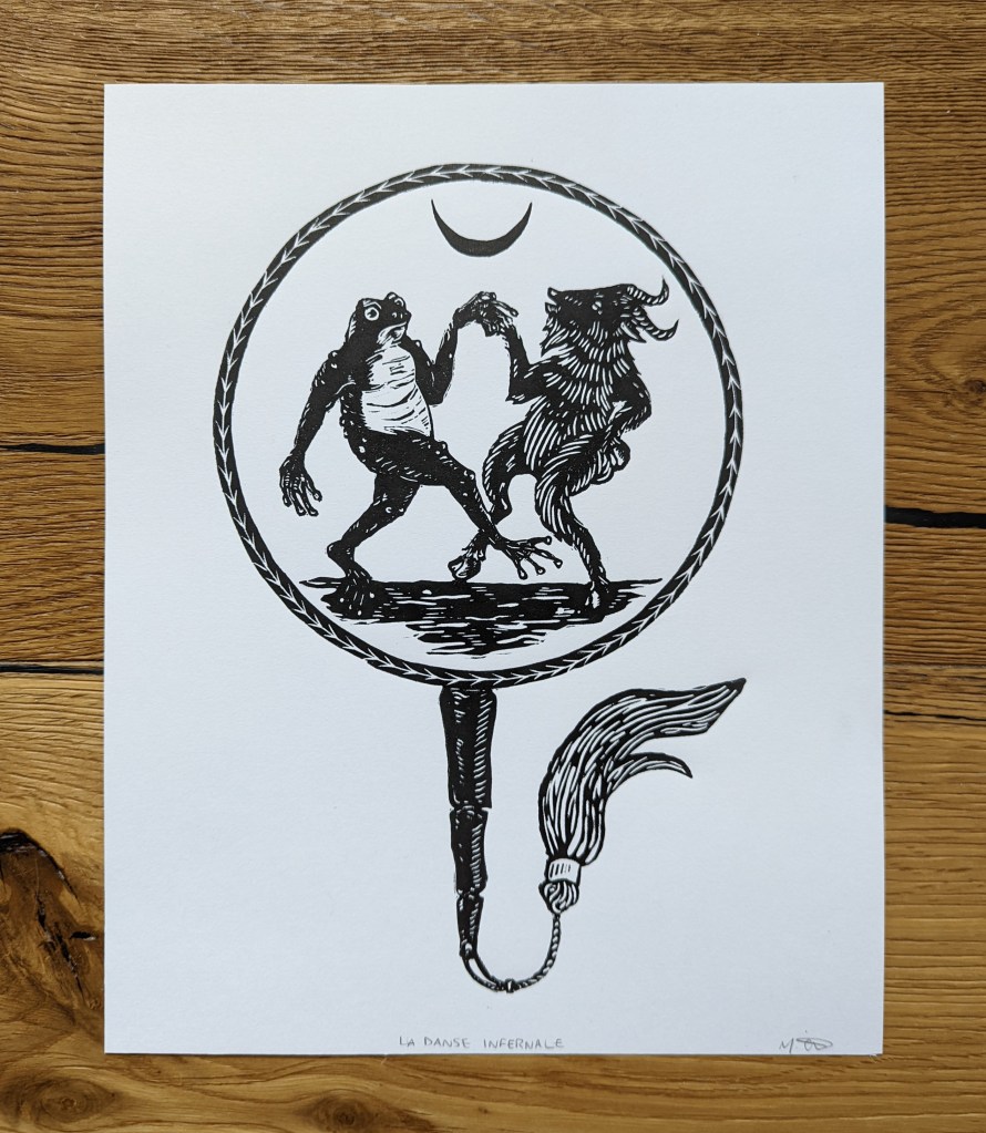 Linoprint of a Chinese-style fan. On the fan, a toad and a goat dance upright.