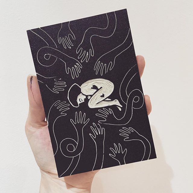 Lino block of a woman curled up as many hands stretch towards her